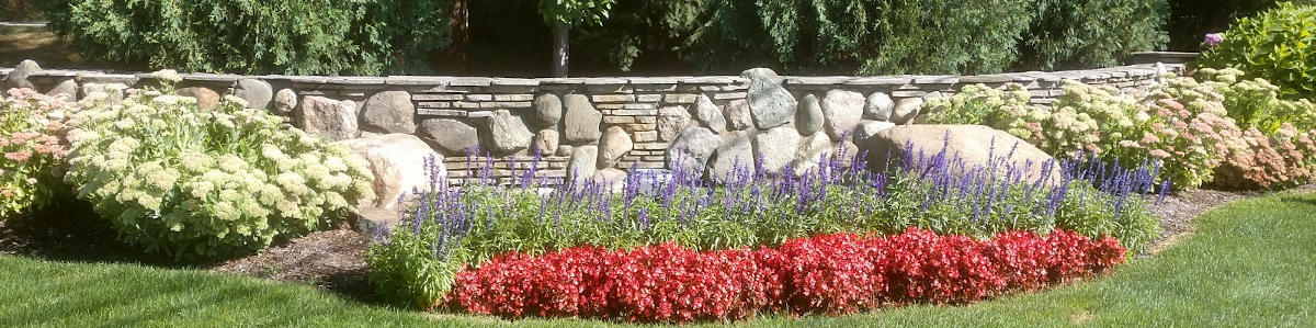 Flower bed condominium entrance with fully grown annuals