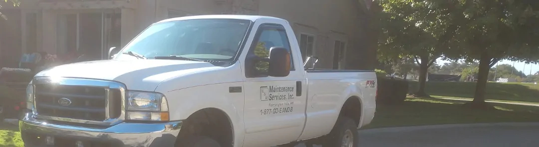 white e and b maintenance services inc. truck with green e and b logo